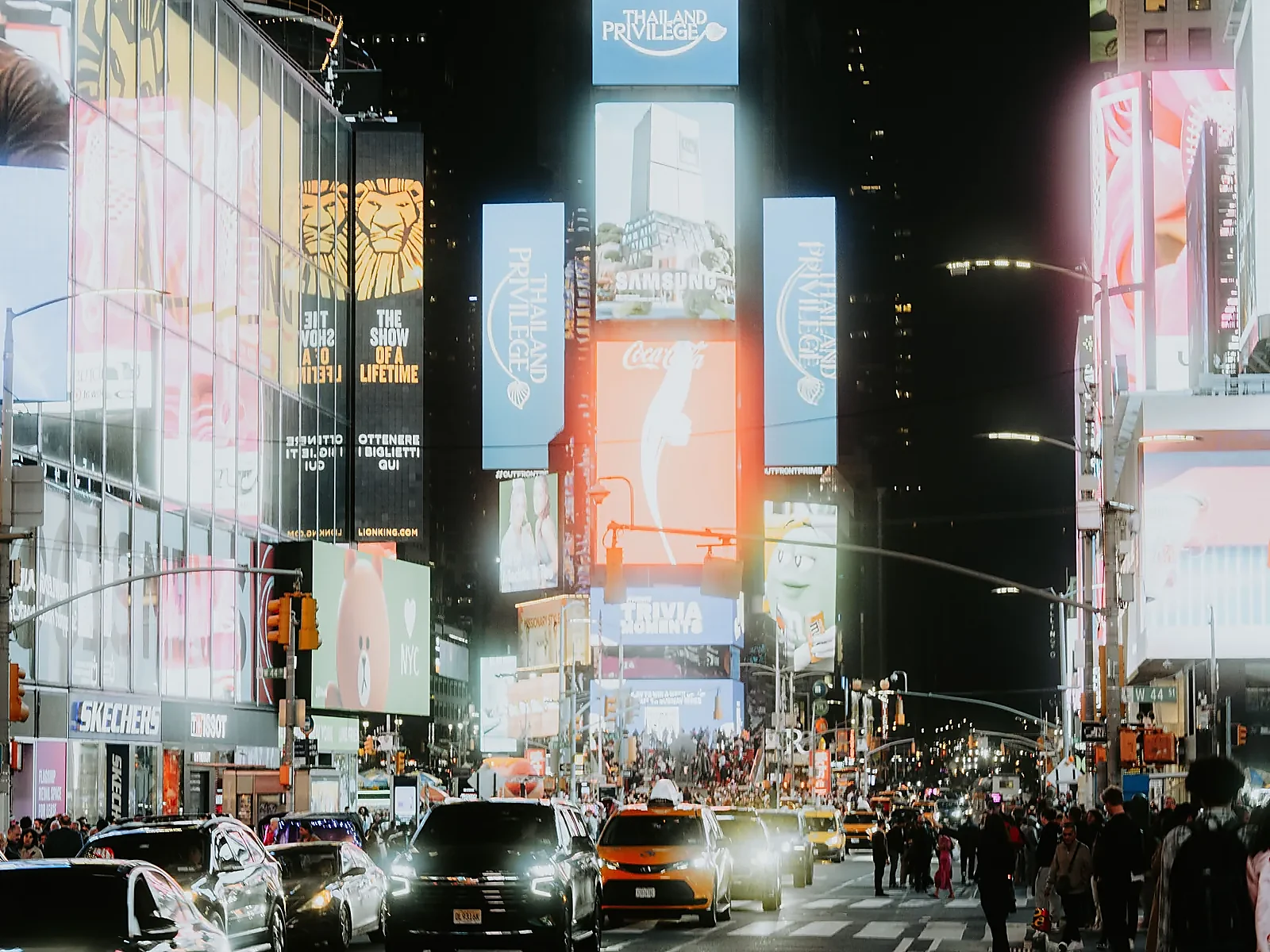 Urban street surrounded by digital out-of-home advertising screens